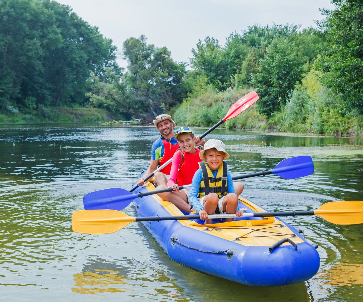 large family in a 3 person kayak with three seat